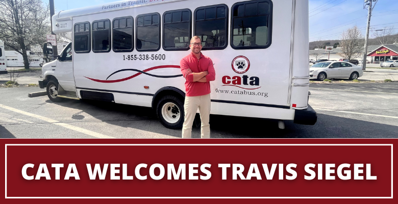 Travis Siegel standing in parking lot with CATA Bus