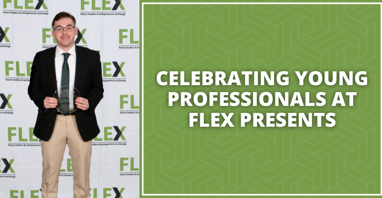 Tyler Vanwormer in suit holding flex presents award